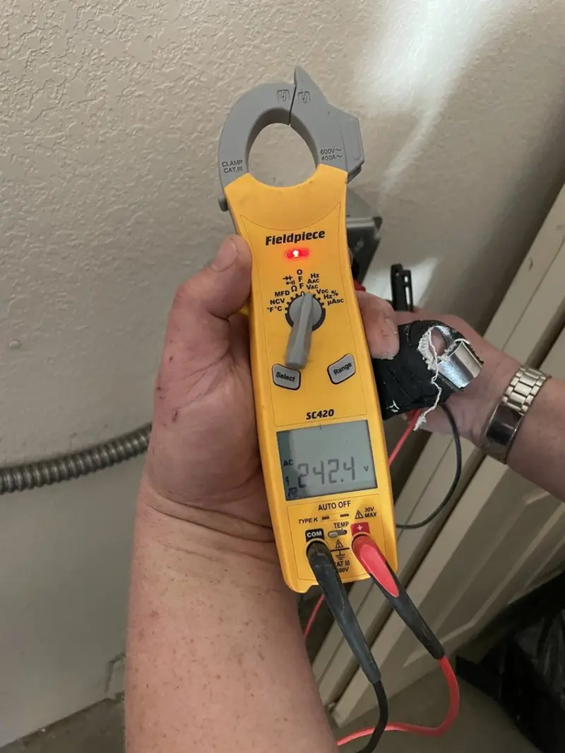 Voltage testing with clamp meter during Outlet Installation in Addison